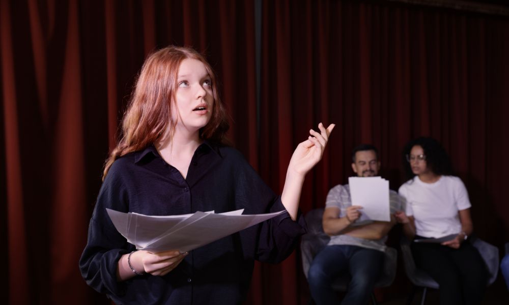An actor practising her lines from a script.